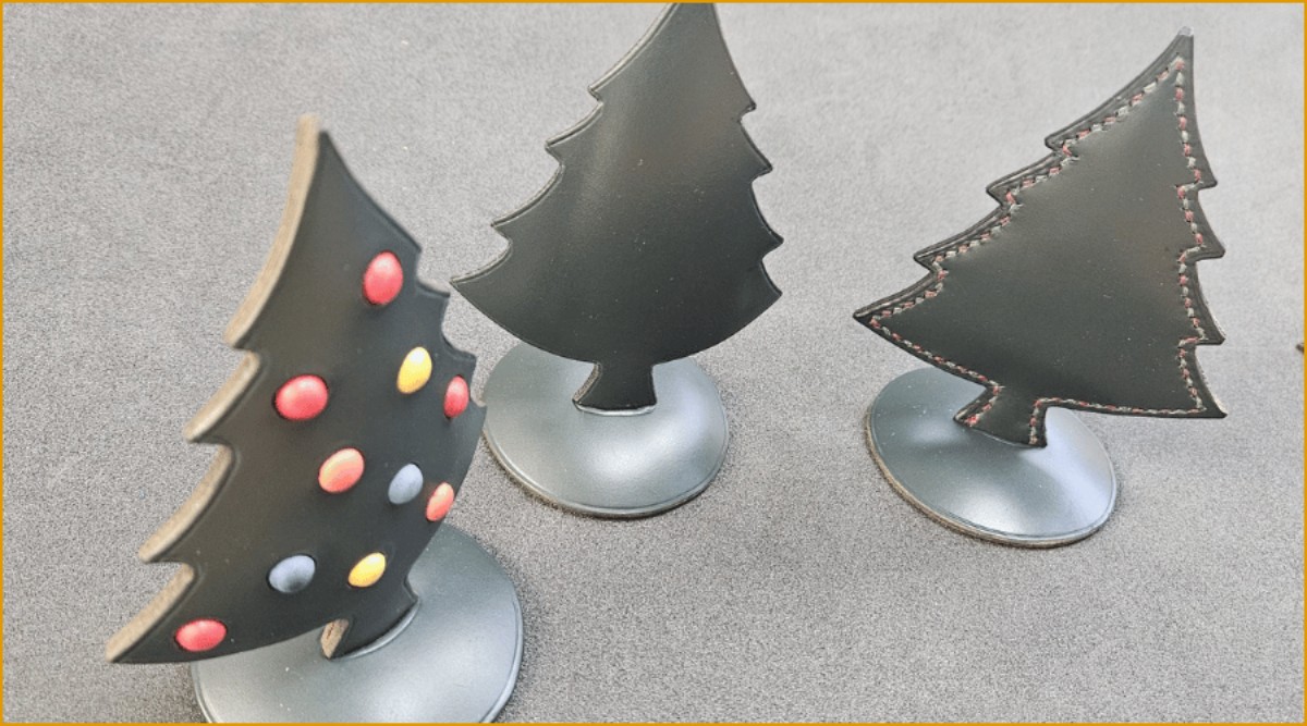 Three leather Christmas trees ornaments with coloured baubles. 