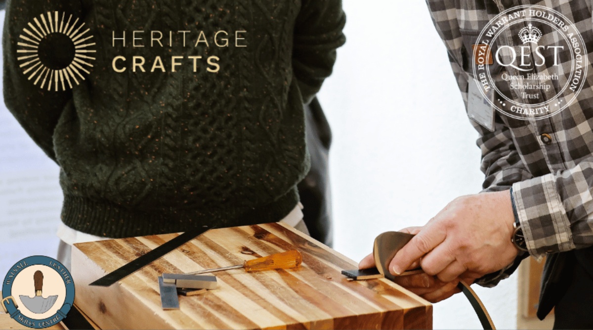 An image at the Walsall Leather Skills Centre of a tutor demonstrating leather work to a student. The Heritage Crafts Logo and Qest Logo are in the top corners and the WLSC logo is bottom left corner.